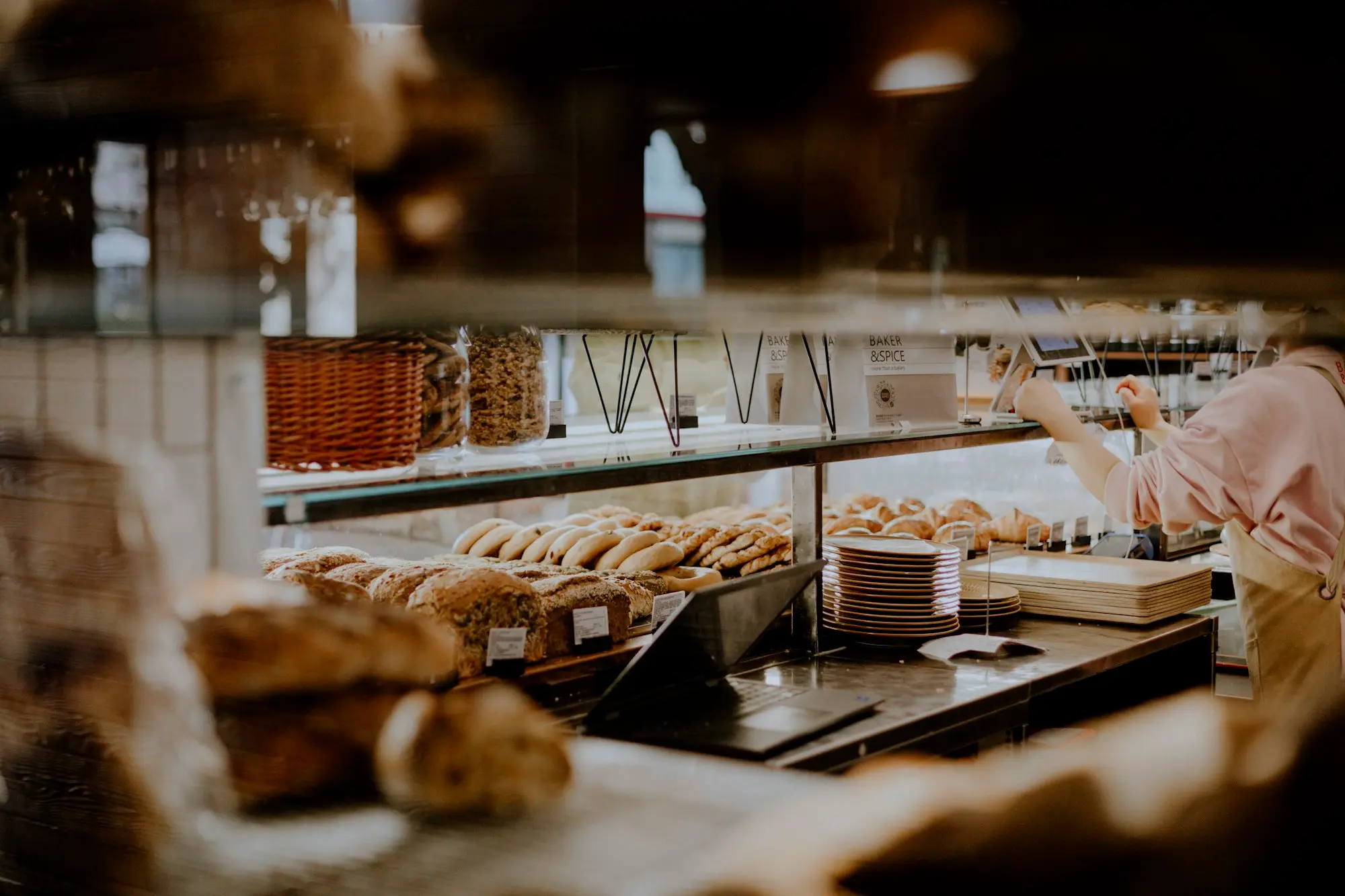 Bakery owner working behind the counter of her shop